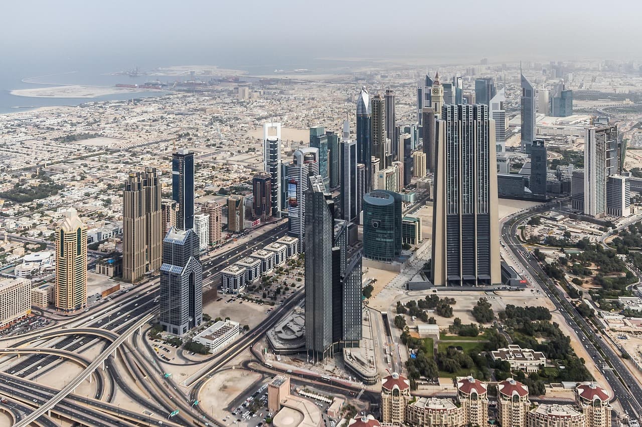 Aerial view of Dubai's Sheikh Zayed Road skyscrapers stretching towards the coast